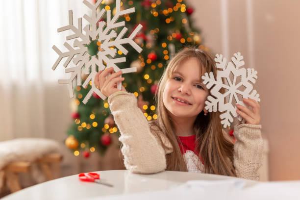 istock Little girl making Christmas decorations 1289928988