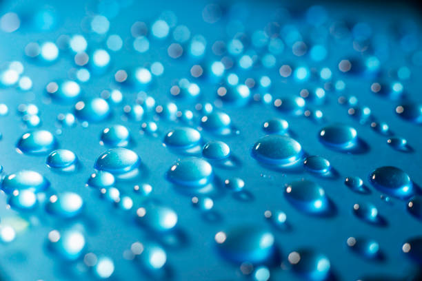 istock Drops of water on blue background 1289929338