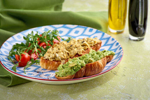 istock Croissant, egg, avocado, arugula, cherry, truffle. Breakfast food concept. 1289929380