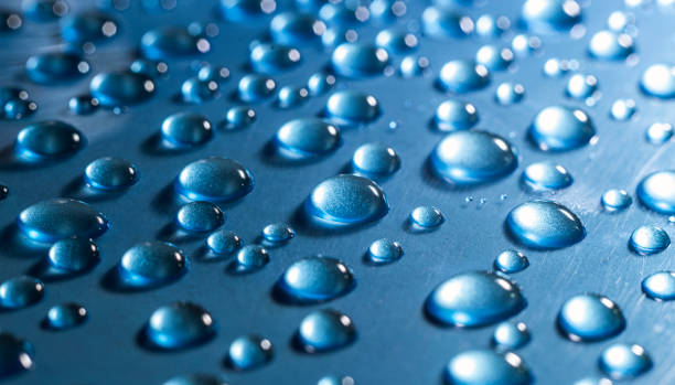istock Drops of water on blue background 1289930148