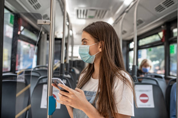 istock Young woman with a protective face mask in a public transportation 1289930202
