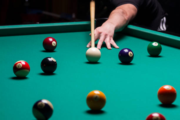 istock Billiard balls in a pool table.stroke; focus on the white ball 1289930404