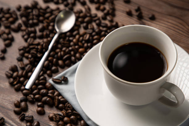 istock Coffee cup and coffee beans on wooden background 1289931469