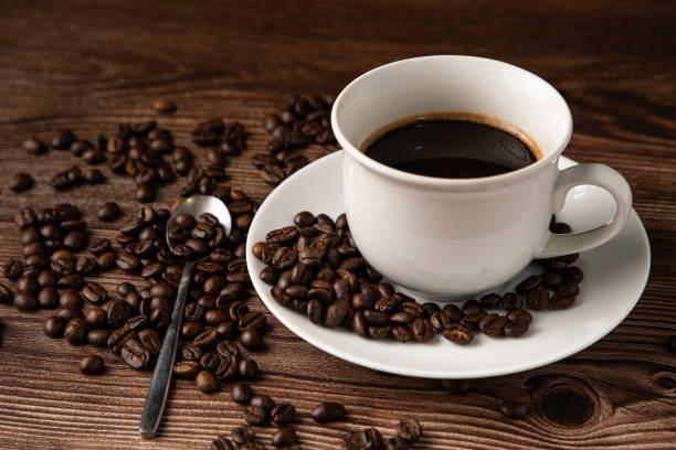 istock Coffee cup and coffee beans on wooden background 1289931470