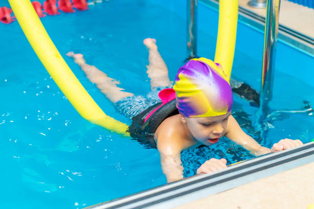 istock Small child swim in an indoor pool. 1289931989