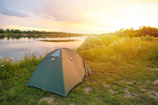 istock tourist tent is by the river in summer 1289934714