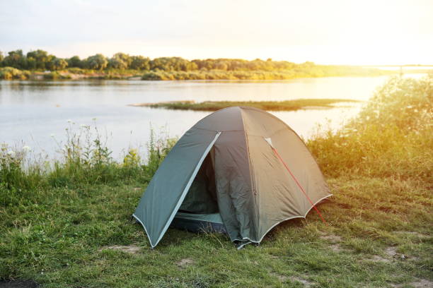 istock tourist tent is by the river in summer 1289934736
