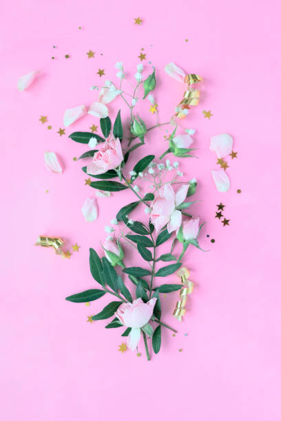 istock Creative layout made with pink and violet flowers on pink background. Flat lay. 1289935982