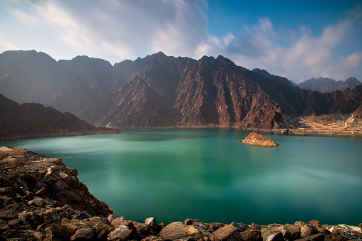 Scenic Hatta dam lake with characteristic mountain range landscape in the background in Dubai emirate of United Arab Emirates