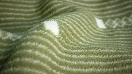 Green wool blanket with geometric motifs