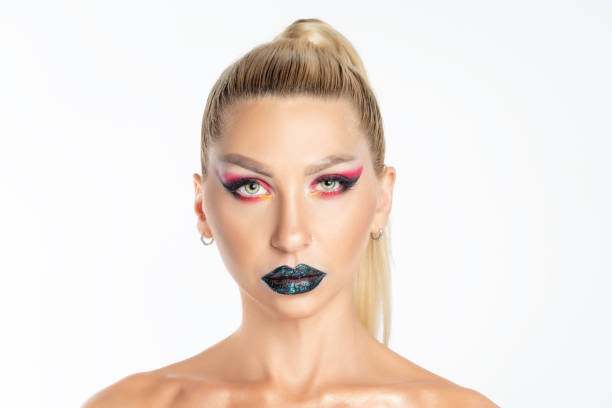 istock Fashion model woman with a bright make-up posing in studio 1289939289