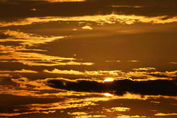 istock fluffy clouds in the golden sky by sunset 1289939809