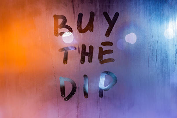 phrase buy the dip handwritten on night wet window glass surface phrase buy the dip handwritten on night wet window glass surface - close-up with selective focus dipping stock pictures, royalty-free photos & images