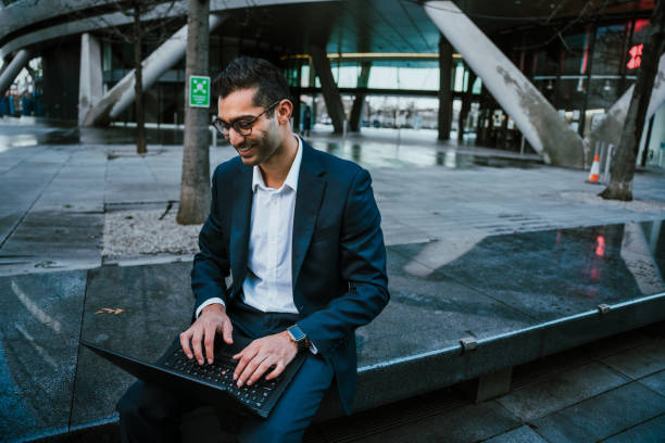 istock Mixed race businessman typing on laptop relaxing during work day 1289942458