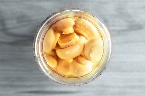 Canned champignons in the bank, top view. Fermented products.