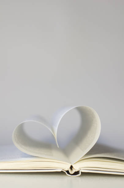 istock Close-up of book pages folded into a heart shape. 1289949287
