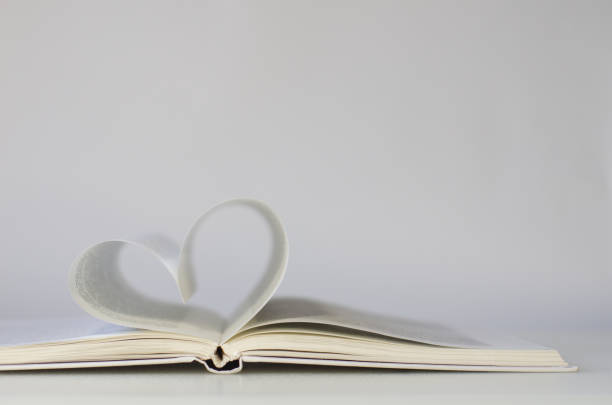 istock Close-up of book pages folded into a heart shape. 1289949297