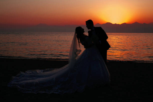 istock Beautiful just married couple at sunset. 1289949577