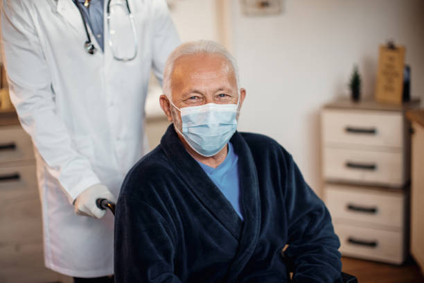 istock Happy senior man wearing protective face mask at nursing home and looking at camera. 1289949793