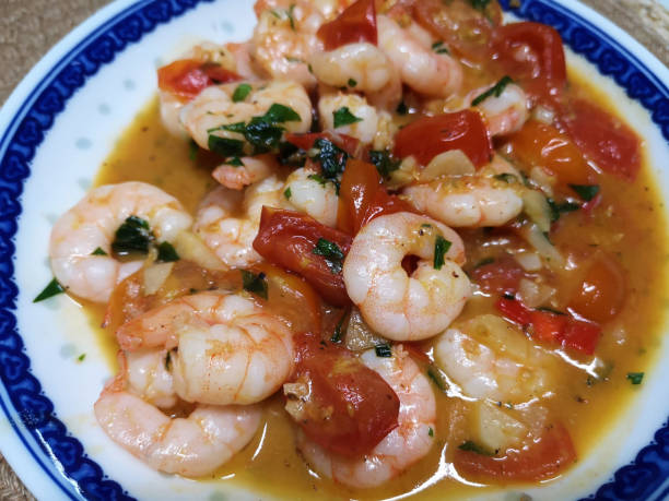 istock Plate of shrimps and cherry tomatoes 1289950722