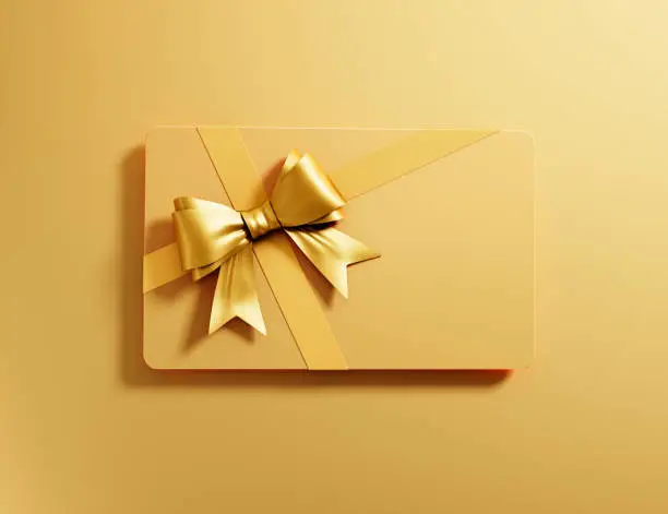 Golden Gift Card with golden Bow on golden Background