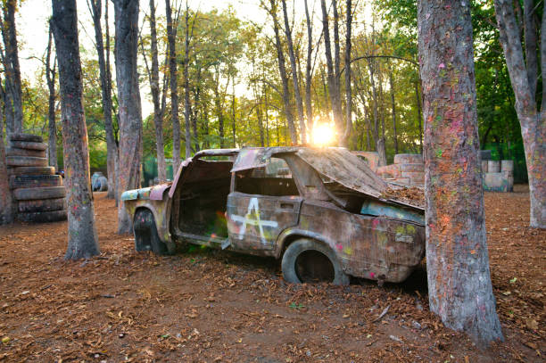 istock Old rusty and abandoned car at the paintball base 1289951327