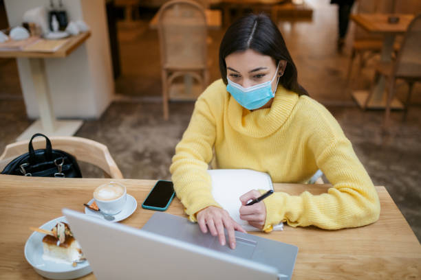 istock Beautiful young Caucasian female freelancer casually working 1289952040