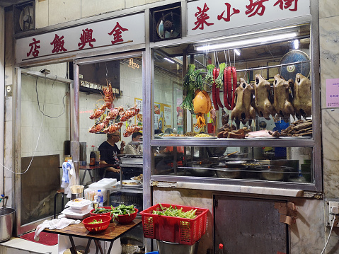 Glass window with ducks, hanging crabs and octopus at a traditional local seafood restaurant in Sai Ying Pun, Western District, in the northwestern part of Hong Kong Island.