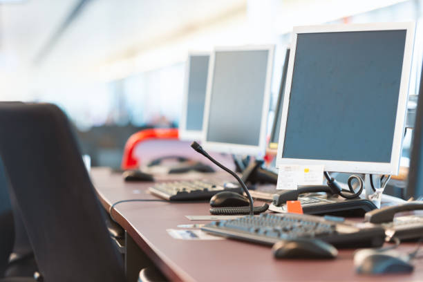 istock Computers at airport boarding gate. No people in image. Focus on nearest display with soft background 1289952223