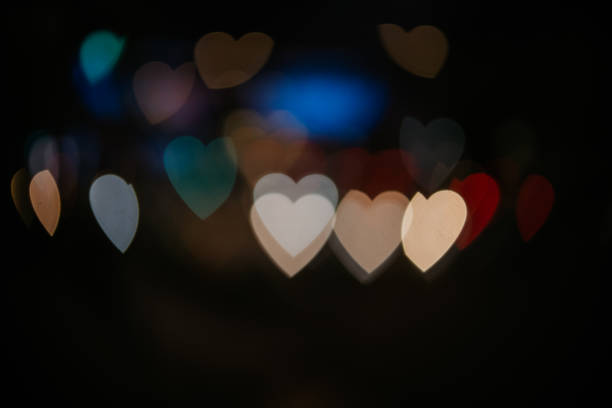 istock Bokeh lights in the shape of hearts 1289953497