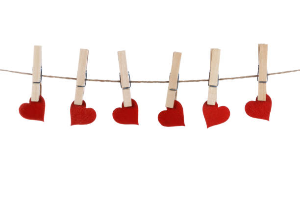 istock Clothes pegs and red paper hearts 1289954062