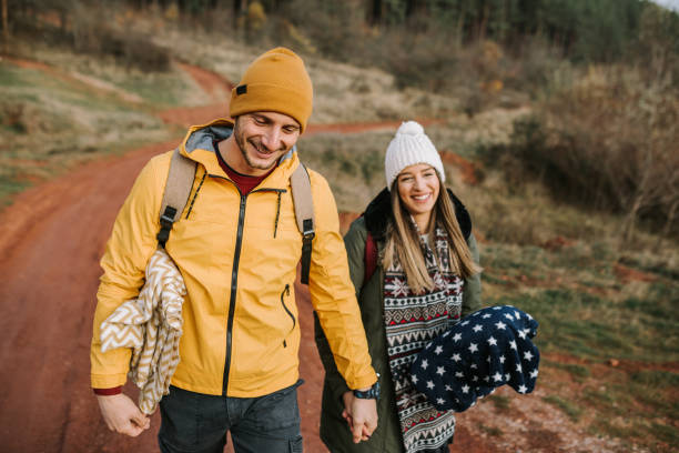 istock Young couple is having fun and smiling while hiking in the nature 1289954979