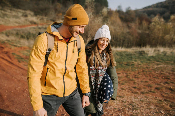 istock Young couple is having fun and smiling while hiking in the nature 1289955066