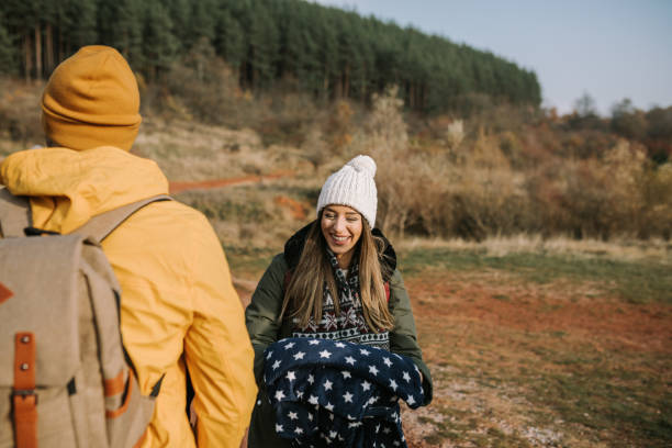 istock Young beautiful woman is smiling and having fun while hiking. 1289955132