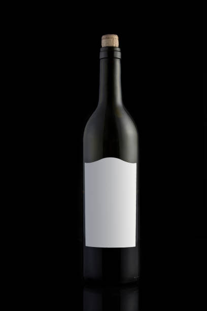 istock Black wine bottle on a black background. Mock-up. Copy space. 1289955293