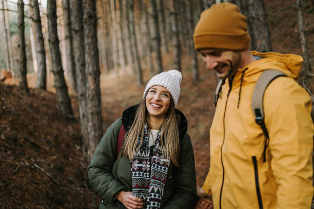 istock Beautiful couple is having fun and smiling in the woods 1289956793