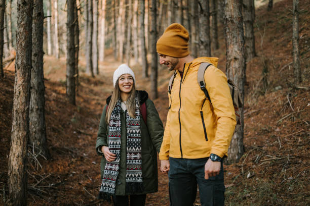 istock Beautiful couple is having fun and smiling in the woods 1289956986