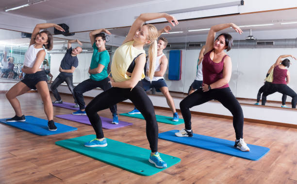 istock Group of young smiling  people studying zumba elements 1289957660