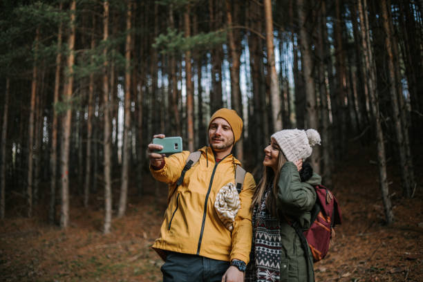 istock Happy couple is taking selfie in the woods. 1289958206