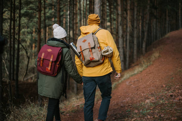 istock Young couple is having fun and smiling while hiking in the nature 1289958273