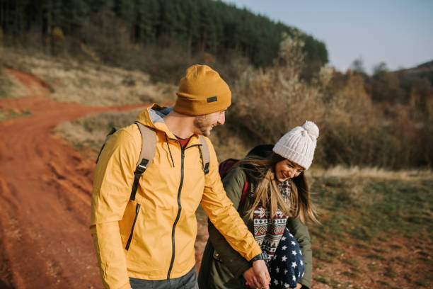 istock Young couple is having fun and smiling while hiking in the nature 1289959389