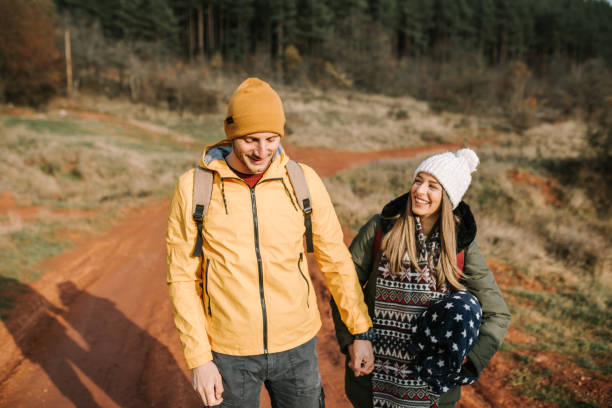 istock Young couple is having fun and smiling while hiking in the nature 1289959428