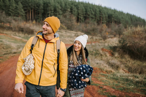 istock Young couple is having fun and smiling while hiking in the nature 1289959507