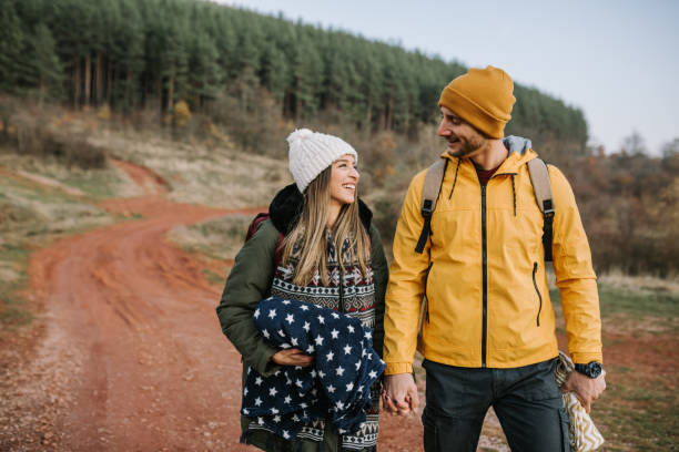 istock Young couple is having fun and smiling while hiking in the nature 1289959545