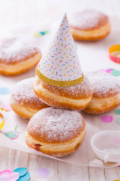Traditional Berliner with party hat for carnival and party.