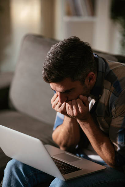 istock The young surprised man with his laptop computer stock photo 1289962043