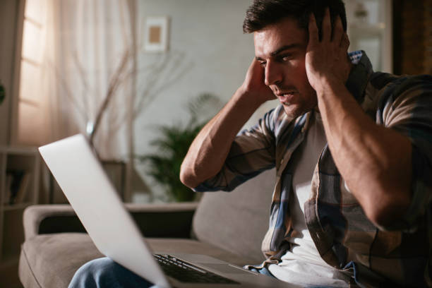 istock The young surprised man with his laptop computer stock photo 1289962163