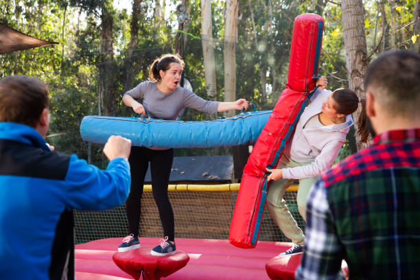 istock Female friends fighting by inflatable logs 1289962626