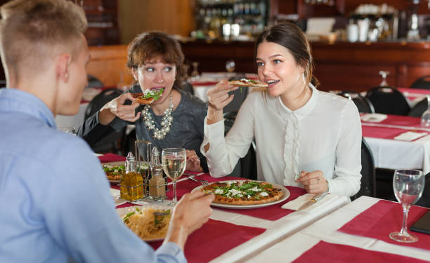 istock Women with man having dinner in restaurant 1289962728