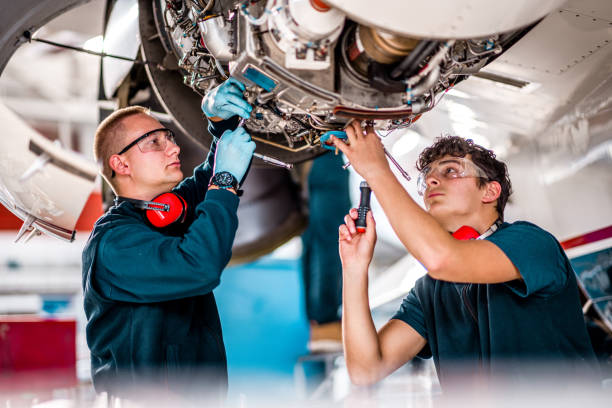 istock Aircraft mechanics working on a jet engine in the airplane hangar 1289963503